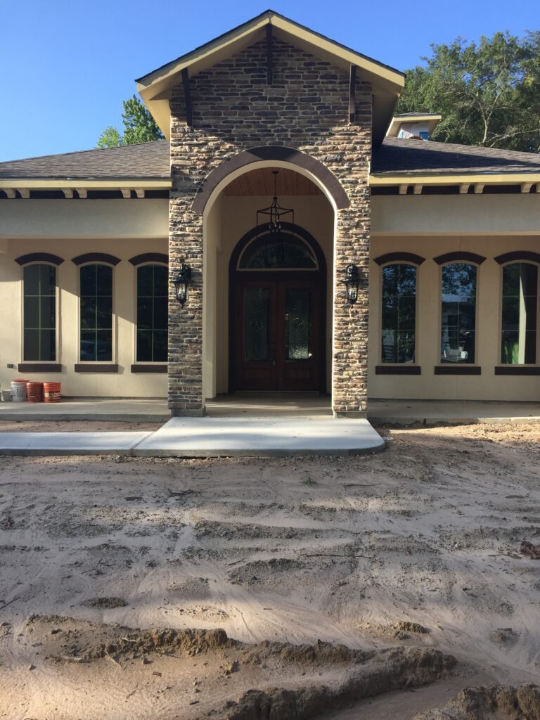 A large building with a stone arch and a door.