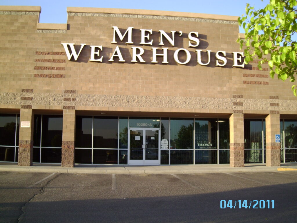 A men 's wearhouse store front with the doors open.