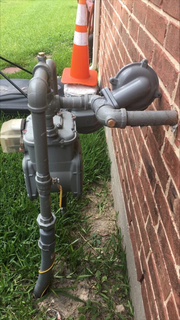 A pipe that is attached to the side of a building.