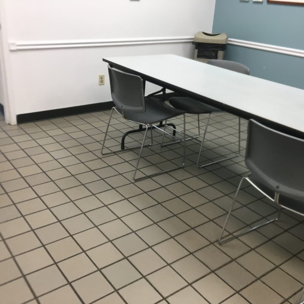 A room with two tables and chairs in it